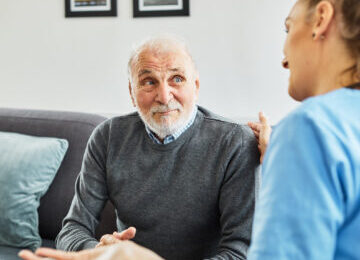 Image showing an older couple discussing bruising after hernia surgery with their doctor.