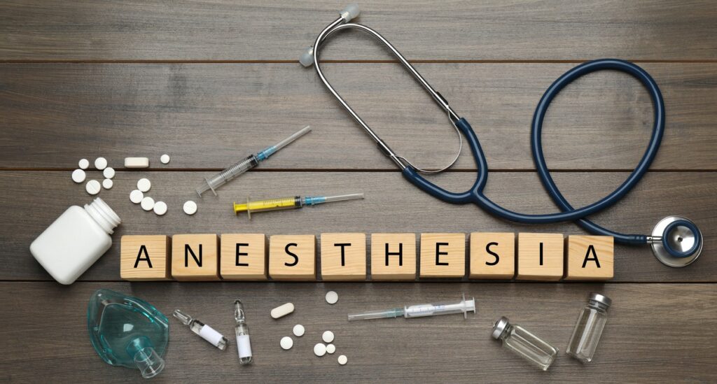 Image showing a stethoscope, a few syringes, pills and blocks spelling out the word "anesthesia."